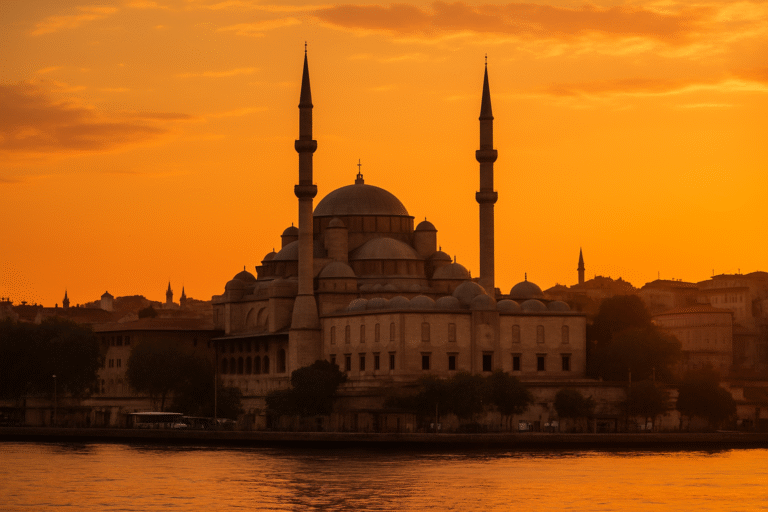 Fatih Mosque in Istanbul at sunset with vibrant orange sky and calm waterfront
